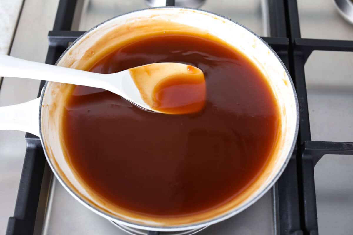 I’ve tested a lot of sweet and sour sauces, and this is the one I always come back to. My recipe uses pineapple juice for that perfect tangy-sweet balance, and it’s ready in minutes with pantry staples. Someone stirring the sauce as it thickens on the stove.