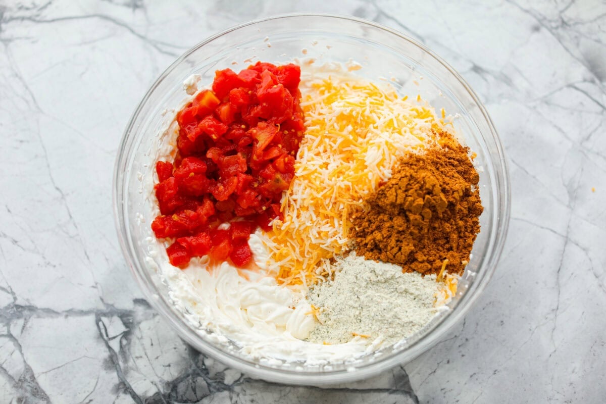 This viral boat dip is blowing up on the socials, and for good reason. It's creamy, cheesy, and the best flavor. It's the easiest appetizer for lake days, BBQs, or any summer hangout. Rotel, cheddar cheese, and seasonings added to the cream cheese mixture.