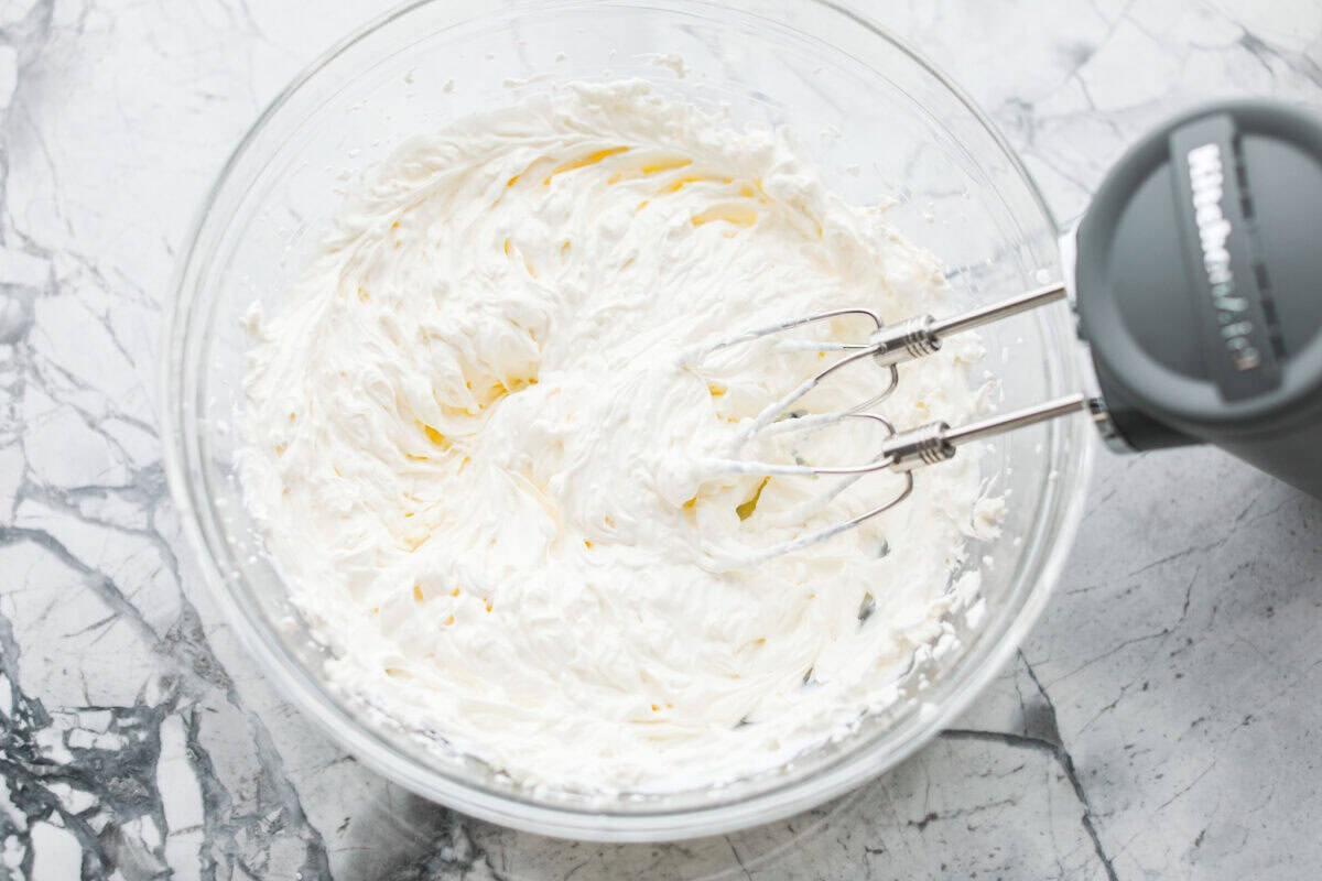 This viral boat dip is blowing up on the socials, and for good reason. It's creamy, cheesy, and the best flavor. It's the easiest appetizer for lake days, BBQs, or any summer hangout. Cream cheese and sour cream being mixed together with a hand mixer.