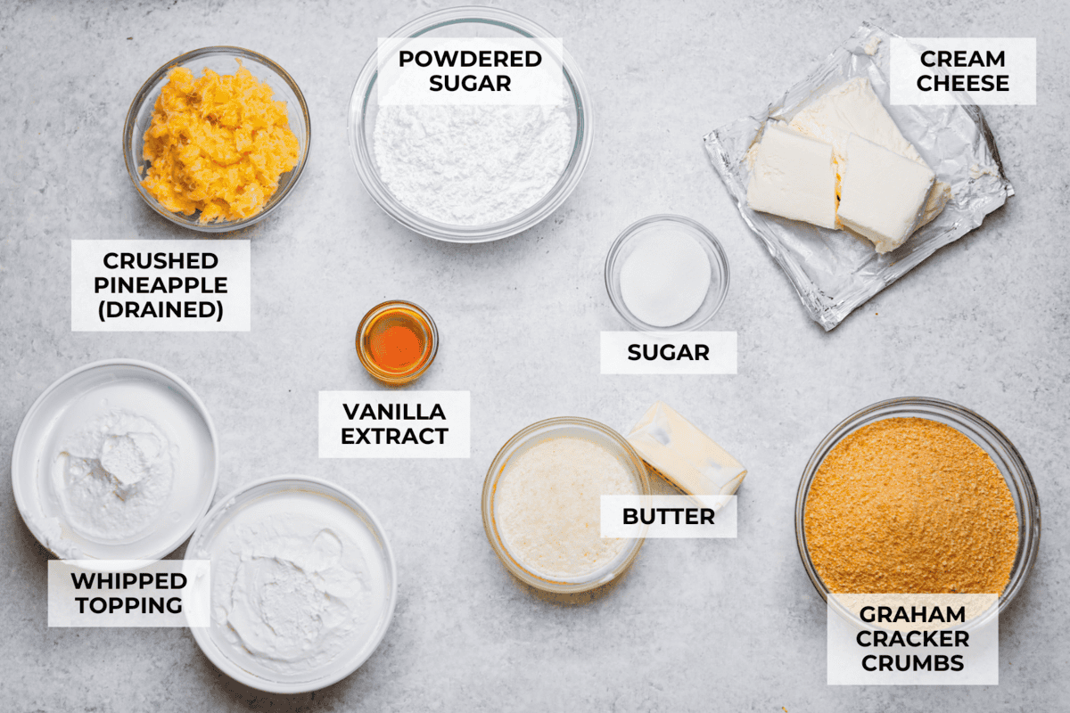 Craving a bright and sunny dessert? This pineapple delight will hit the spot! With a buttery crust, creamy filling, and sweet pineapple topping, it’s light, tropical, and totally irresistible! Overhead shot of labeled pineapple delight ingredients.