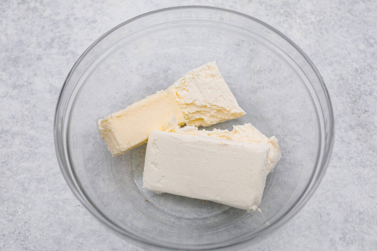 Cream cheese and butter added to a bowl. 