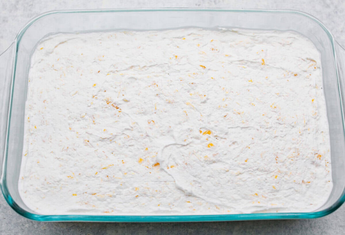 Whipped topping added to the top of the cream cheese mixture, ready to go in the fridge to chill. 