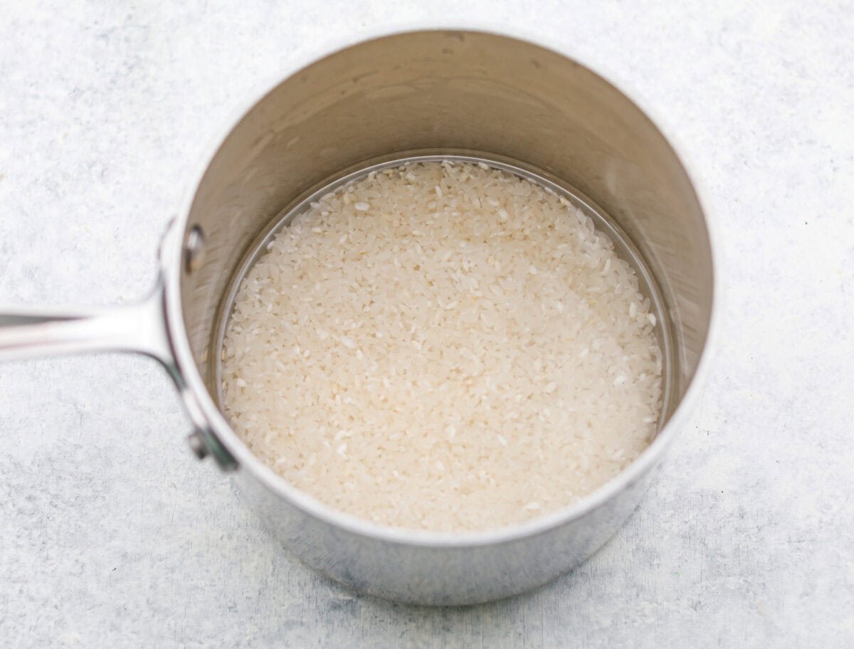 Rice in a pot with water, read to be cooked. 