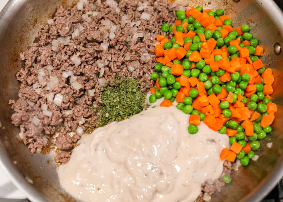 If you love shepherd’s pie, you’ve got to try this Tater Tot Casserole! It’s the ultimate lazy-girl version, with tots instead of mashed potatoes, melty cheese, hearty beef, and total comfort in every bite. The kids will absolutely devour it. Veggies and soup mix added to the cooked ground beef.