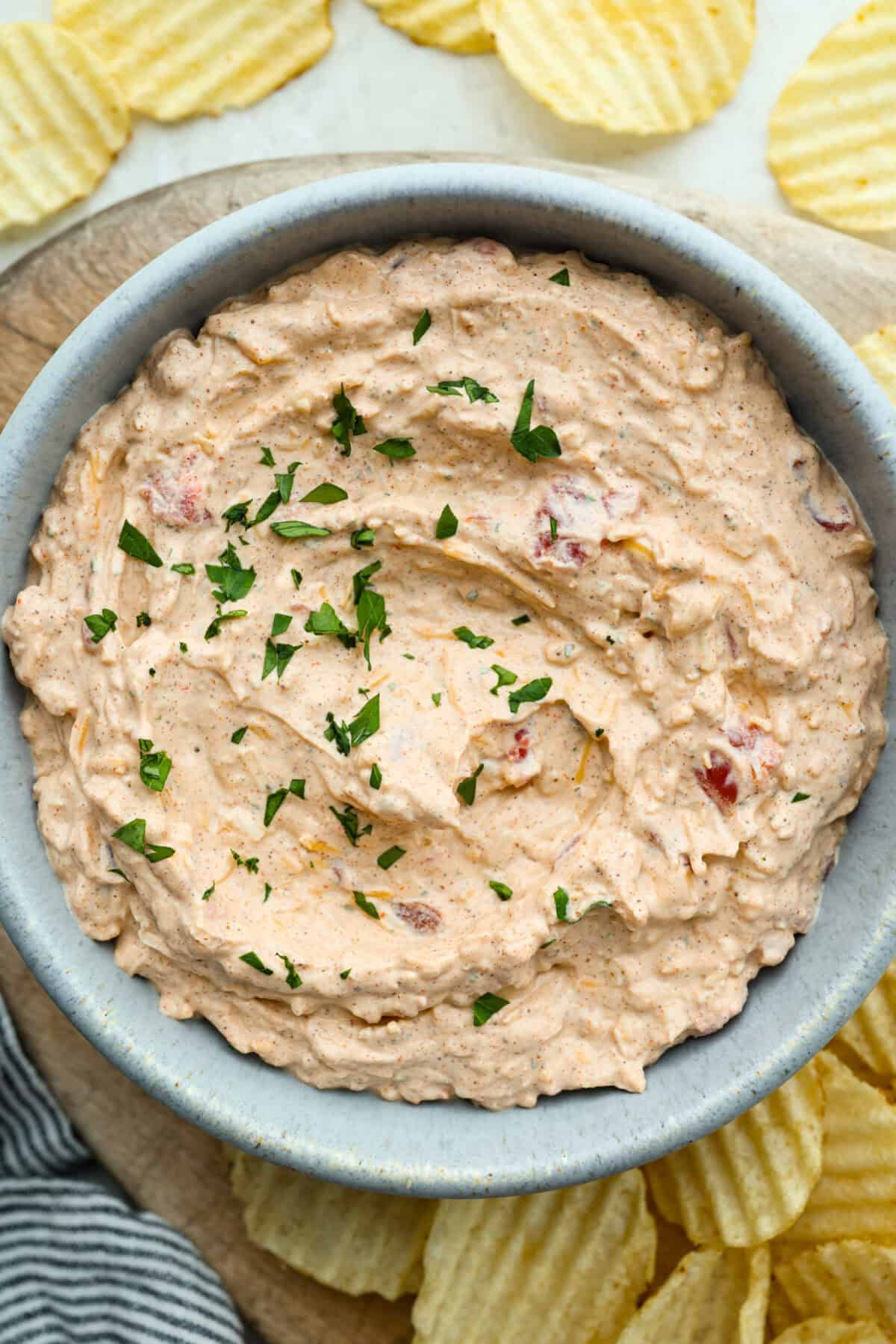 This viral boat dip is blowing up on the socials, and for good reason. It's creamy, cheesy, and the best flavor. It's the easiest appetizer for lake days, BBQs, or any summer hangout. Bowl of Boat Dip in a serving bowl, garnished with cilantro.