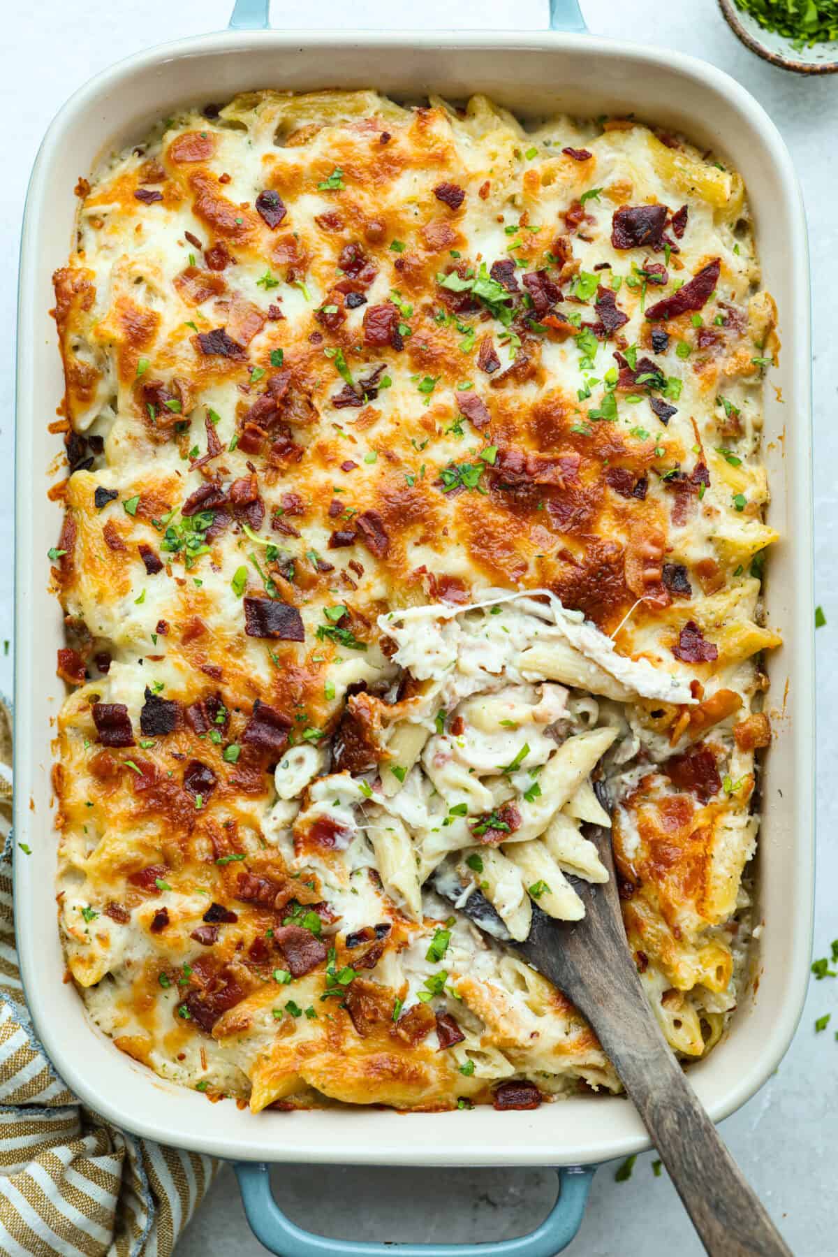 Want to make something you know your kids will eat? This chicken bacon ranch casserole is it! I can't tell you how delicious this casserole is! The combination of flavors is perfection! You have to try it! Overhead shot of chicken bacon ranch casserole in the baking dish.