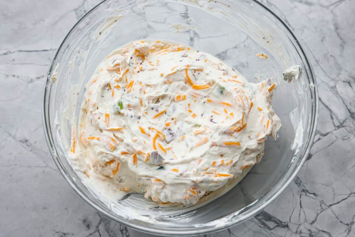 Creamy, cheesy, and loaded with crack dip flavor! This 6-ingredient appetizer is served cold and ready in just 10 minutes. Good luck keeping it on the table. All of the ingredients mixed together in a bowl.