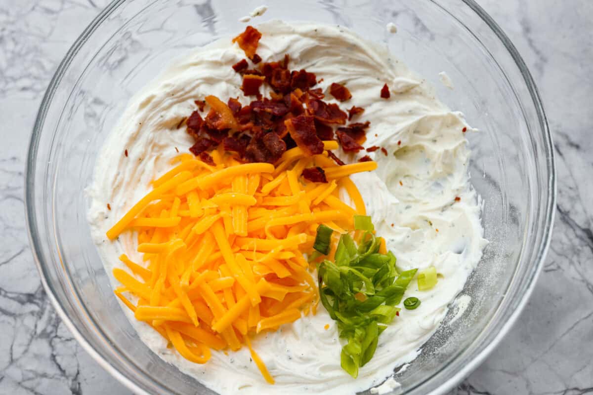 Creamy, cheesy, and loaded with crack dip flavor! This 6-ingredient appetizer is served cold and ready in just 10 minutes. Good luck keeping it on the table. Cheese, bacon, and green onions added to the cream cheese mixture.