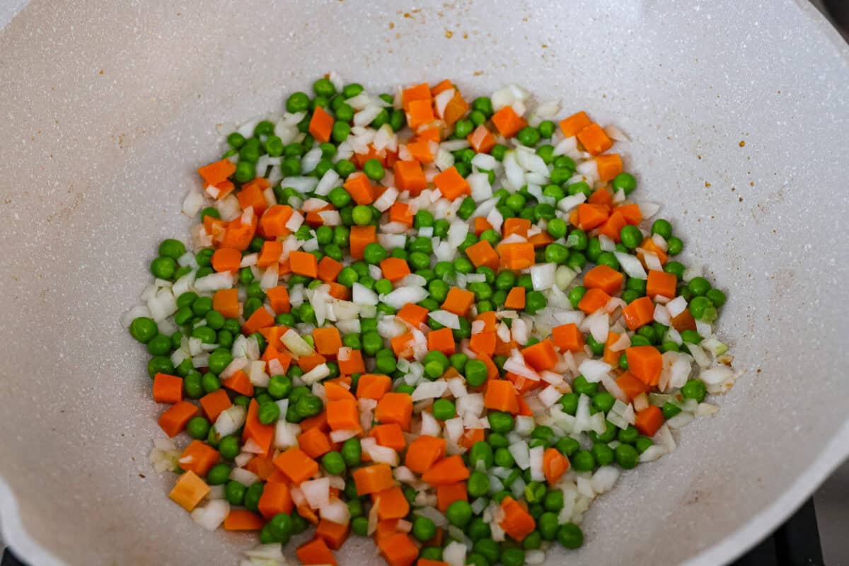 Veggies cooking in a skillet. 