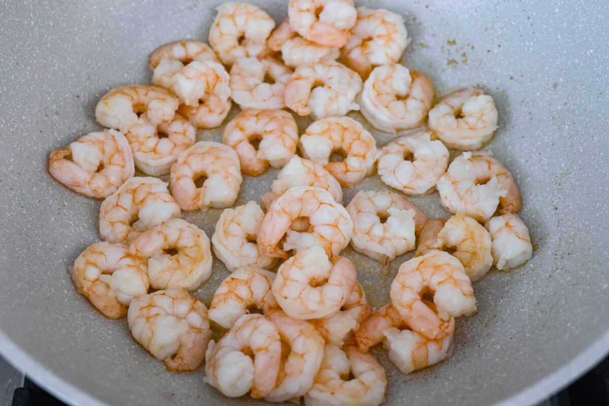 Shrimp cooking in a skillet.