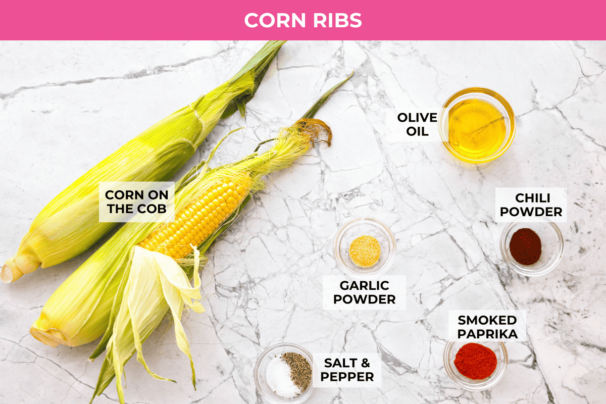 I had to try these viral Corn Ribs, and now I totally get the hype! They're fun, handheld, and smothered in creamy, zesty Mexican street corn flavor. Make a batch to share... or don’t. I won’t judge. Overhead shot of labeled corn rib ingredients.