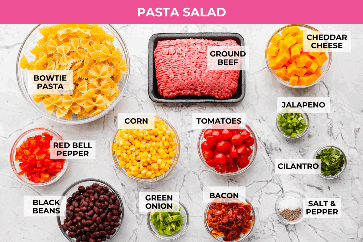 Yeehaw! My cowboy pasta salad is loaded with beef, bacon, beans, and all the fixings for all you cowboy lovers. You'll get all the flavors of the Wild West tossed in the tastiest cowboy salad dressing. Overhead shot of labeled pasta salad ingredients.