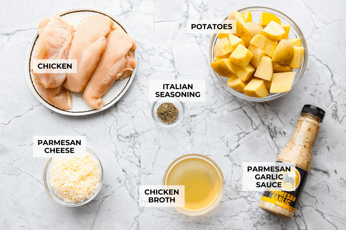 This viral slow cooker Parmesan garlic chicken has juicy meat, tender potatoes, and a sauce so rich and creamy that scooping it with a spoon won’t cut it. You’ll want to drink it, or let’s be real, bathe in it. Overhead shot of labeled ingredients.