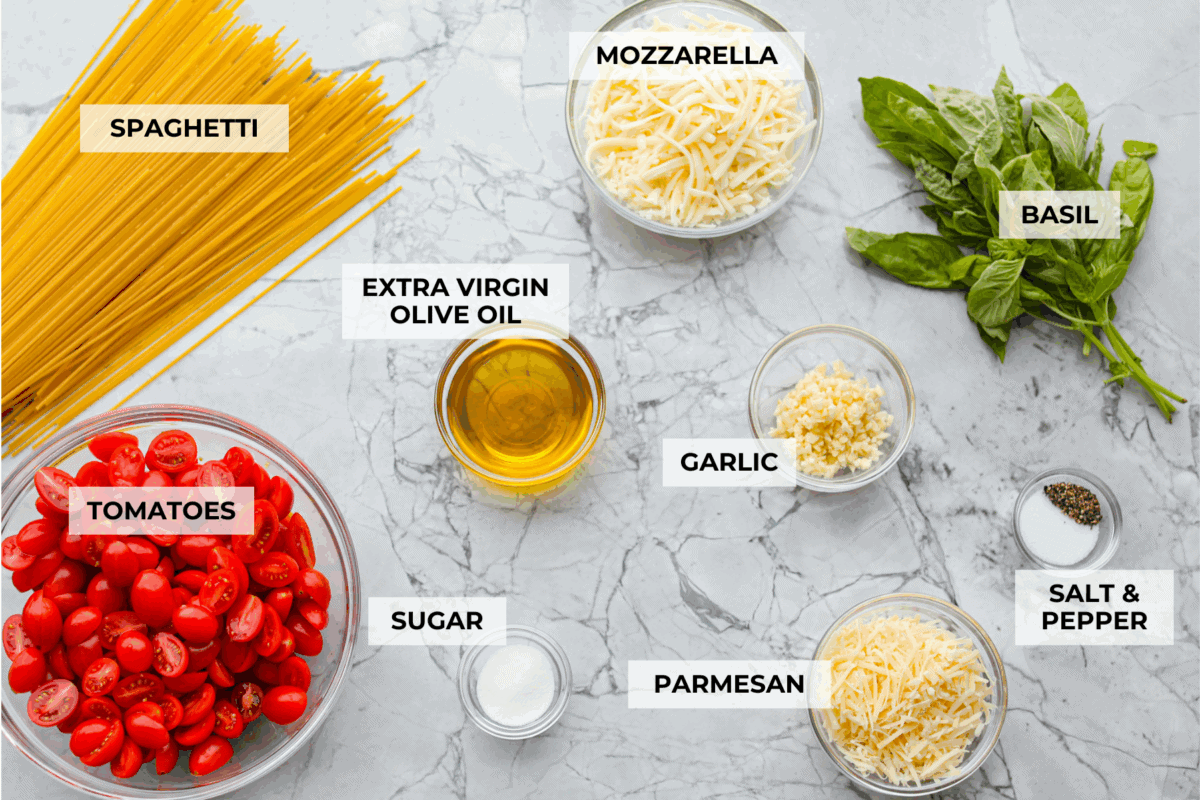 Spaghetti Margherita has been a family favorite since I was a kid, though we just called it “pasta with tomato and basil.” It’s simple, fresh, and so full of flavor, even my meat-loving husband can’t get enough! Overhead shot of labeled ingredients.