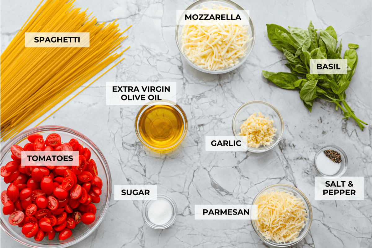 Spaghetti Margherita has been a family favorite since I was a kid, though we just called it “pasta with tomato and basil.” It’s simple, fresh, and so full of flavor, even my meat-loving husband can’t get enough! Overhead shot of labeled ingredients.