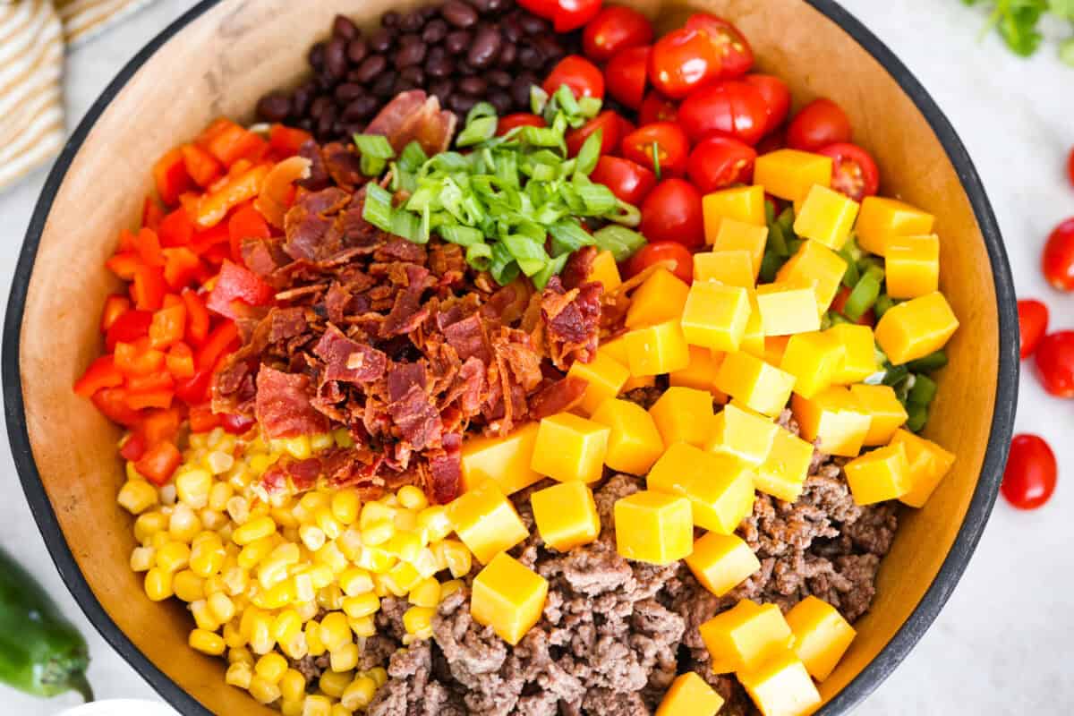 Yeehaw! My cowboy pasta salad is loaded with beef, bacon, beans, and all the fixings for all you cowboy lovers. You'll get all the flavors of the Wild West tossed in the tastiest cowboy salad dressing. All of the pasta salad ingredients in a serving bowl.