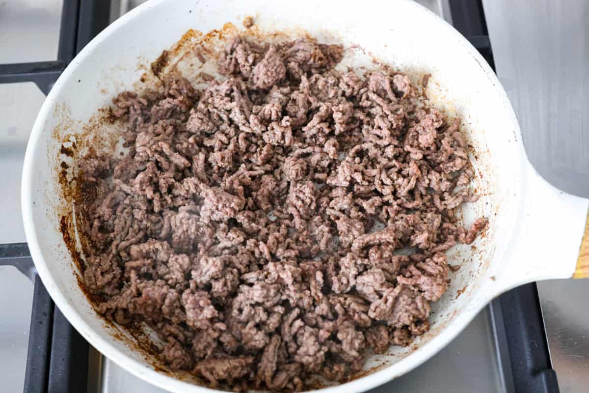 Yeehaw! My cowboy pasta salad is loaded with beef, bacon, beans, and all the fixings for all you cowboy lovers. You'll get all the flavors of the Wild West tossed in the tastiest cowboy salad dressing. Ground beef cooking in a skillet.