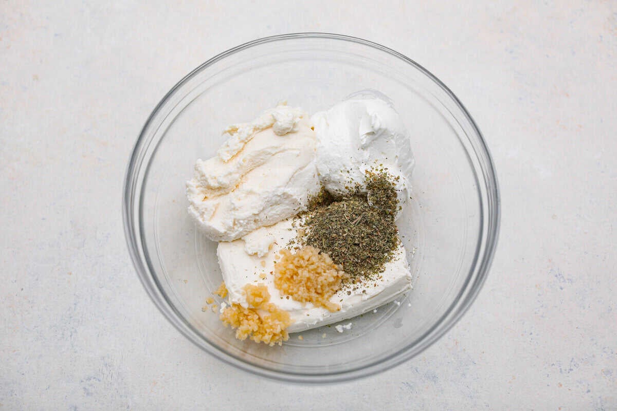 Crockpot million dollar pasta is rich, creamy, and straight-up dreamy. No boiling, no babysitting, just toss it all in and let your slow cooker work its magic! Million dollar cheese sauce ingredients in a bowl.