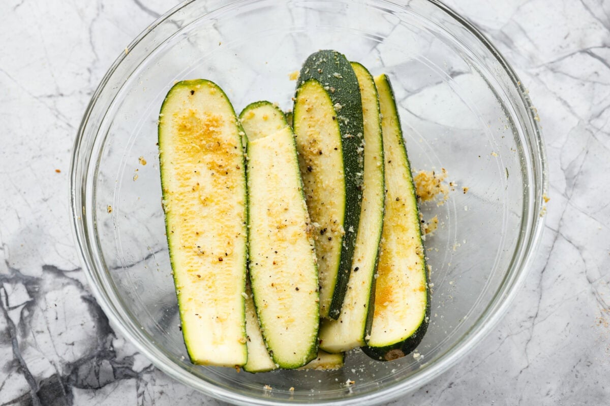 All of the zucchin slices covered in cheese and seasonings. 