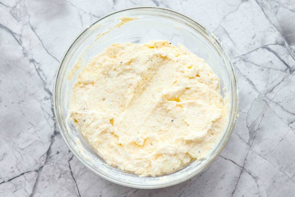 They don’t call it Marry Me Lasagna for nothing! One bite of the creamy sauce, tender chicken, and melty cheese, and everyone will be saying, "YES!" Ricotta cheese, parmesan, egg, salt, and pepper mixed together in a bowl.