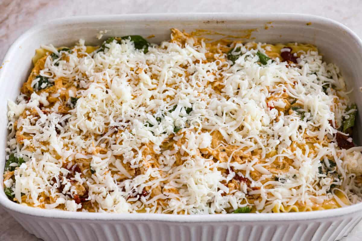 They don’t call it Marry Me Lasagna for nothing! One bite of the creamy sauce, tender chicken, and melty cheese, and everyone will be saying, "YES!" Last layer of cheese added to the top of the marry me lasagna ready to be covered with foil before it goes into the oven.