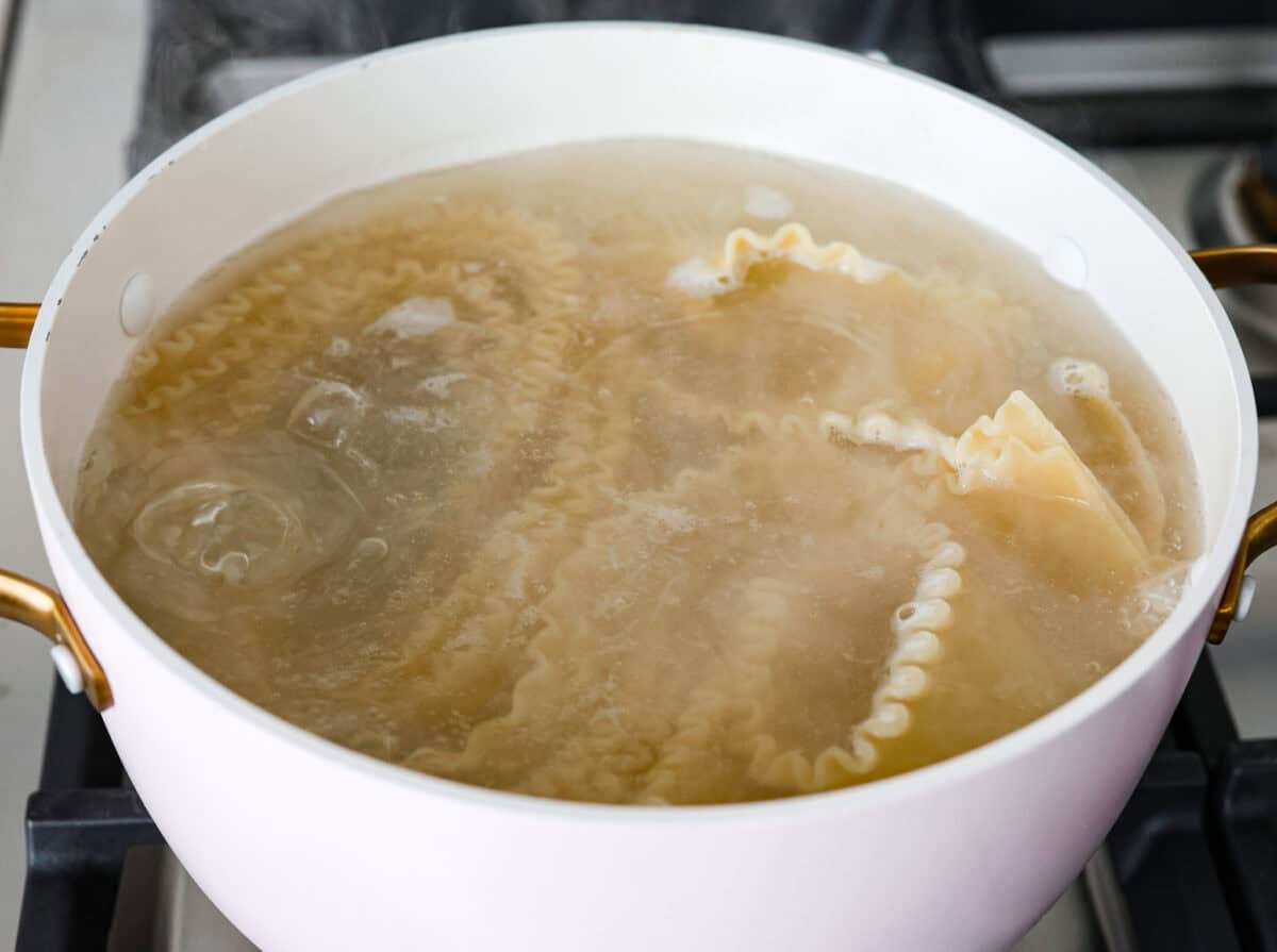 They don’t call it Marry Me Lasagna for nothing! One bite of the creamy sauce, tender chicken, and melty cheese, and everyone will be saying, "YES!" Lasagna noodles in boiling water in a pot.