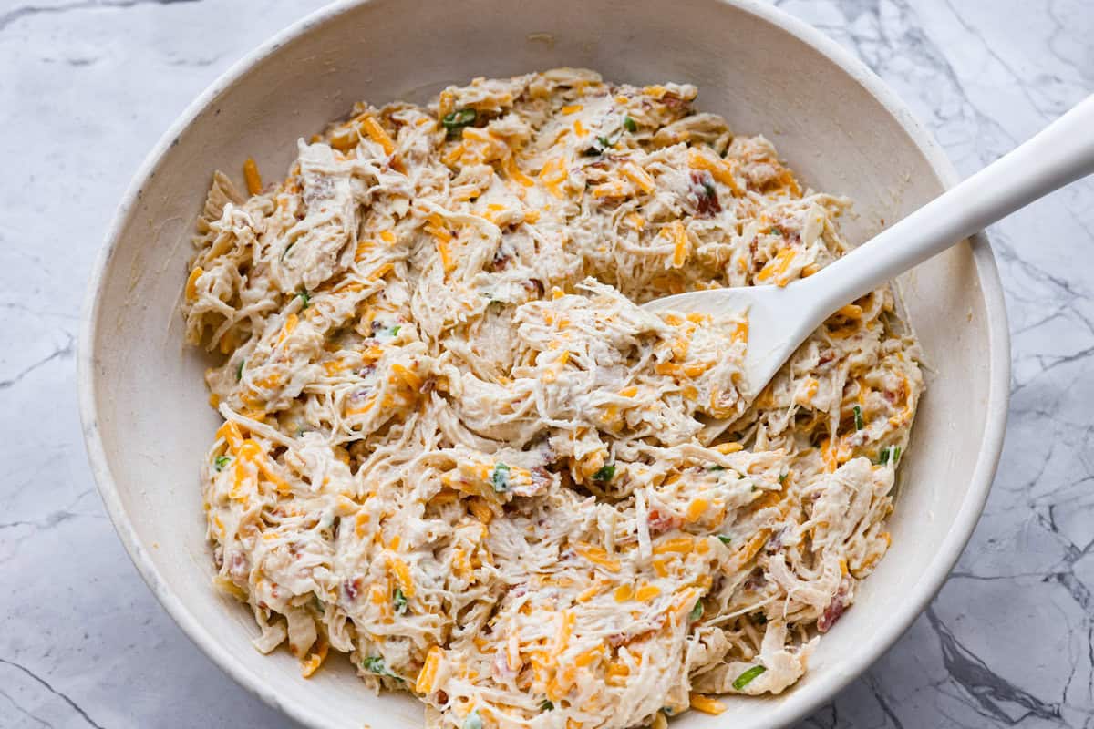 Neiman Marcus Chicken Casserole is boujee on a budget. It’s creamy, comforting, and topped with a buttery, golden cracker crust. Inspired by a recipe from the iconic department store’s café, this casserole tastes amazing and comes together fast. Casserole ingredients in a bowl mixed together.