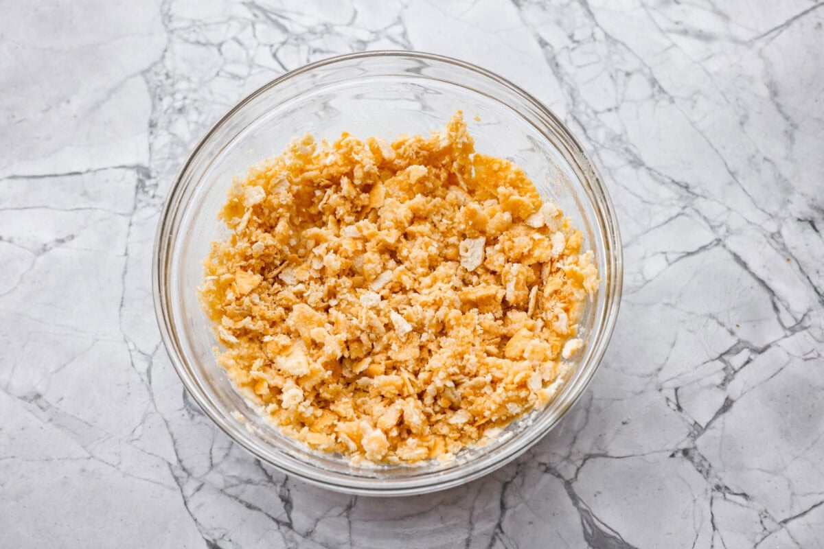 Neiman Marcus Chicken Casserole is boujee on a budget. It’s creamy, comforting, and topped with a buttery, golden cracker crust. Inspired by a recipe from the iconic department store’s café, this casserole tastes amazing and comes together fast. Crushed ritz crackers mixed with melted butter in a bowl.
