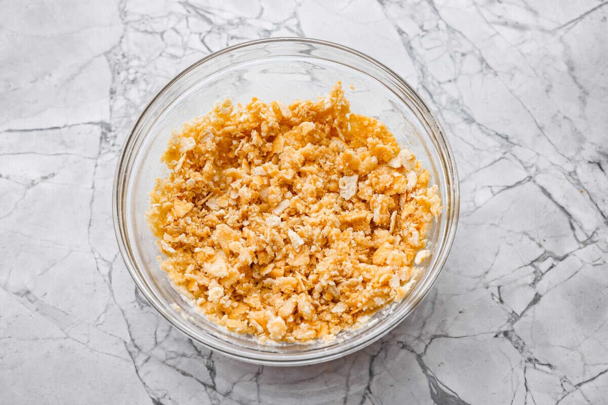 Neiman Marcus Chicken Casserole is boujee on a budget. It’s creamy, comforting, and topped with a buttery, golden cracker crust. Inspired by a recipe from the iconic department store’s café, this casserole tastes amazing and comes together fast. Crushed ritz crackers mixed with melted butter in a bowl.