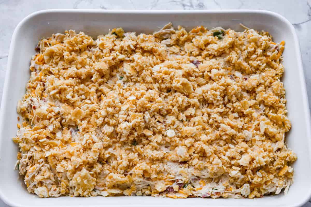 Neiman Marcus Chicken Casserole is boujee on a budget. It’s creamy, comforting, and topped with a buttery, golden cracker crust. Inspired by a recipe from the iconic department store’s café, this casserole tastes amazing and comes together fast. Casserole ingredients topped with ritz cracker crumb topping.