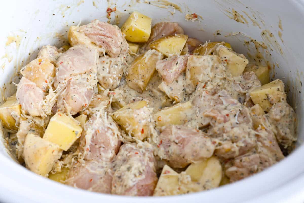 This viral slow cooker Parmesan garlic chicken has juicy meat, tender potatoes, and a sauce so rich and creamy that scooping it with a spoon won’t cut it. You’ll want to drink it, or let’s be real, bathe in it. All of the ingredients mixed together in the crockpot.