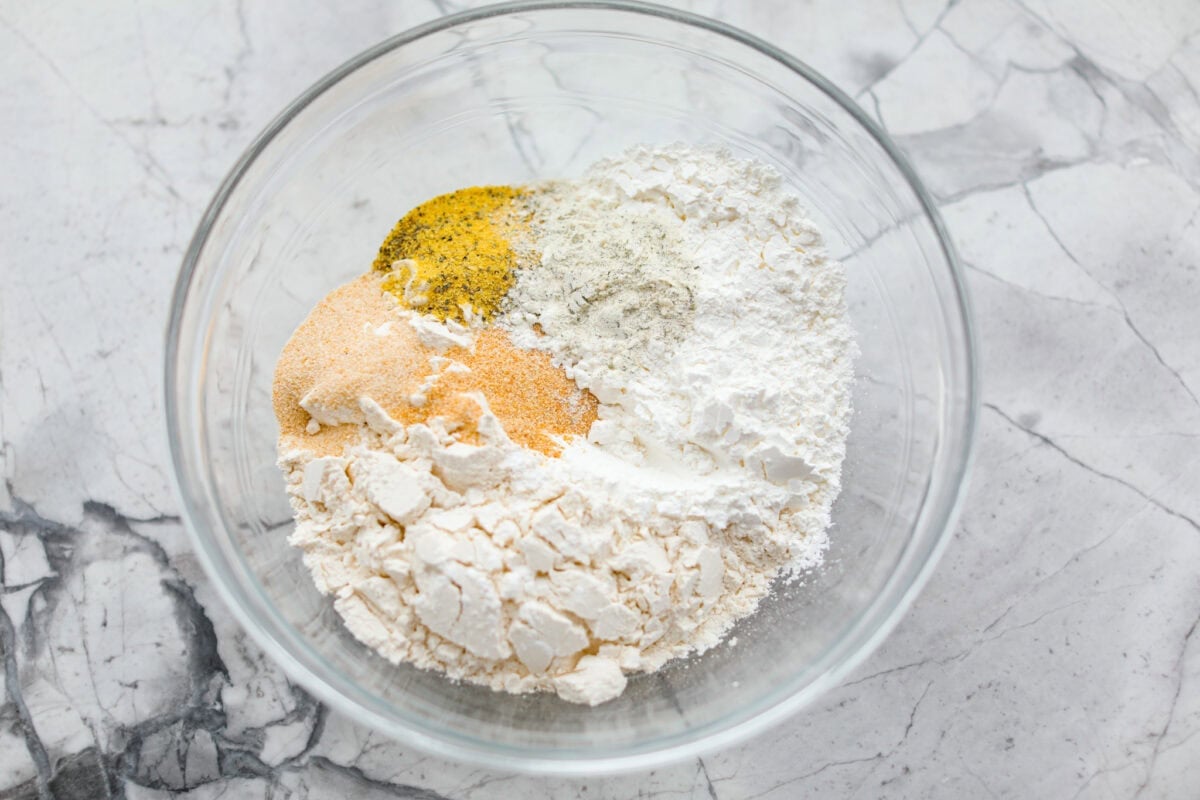 Meet your new wing obsession: Crack Wings. Salty, tangy, peppery, with a touch of sweetness. I've never seen a wing with a powder dusting so full of flavor! They are addictive because of the salty and sweet combo with that hint of heat. Bowl of breading ingredients.