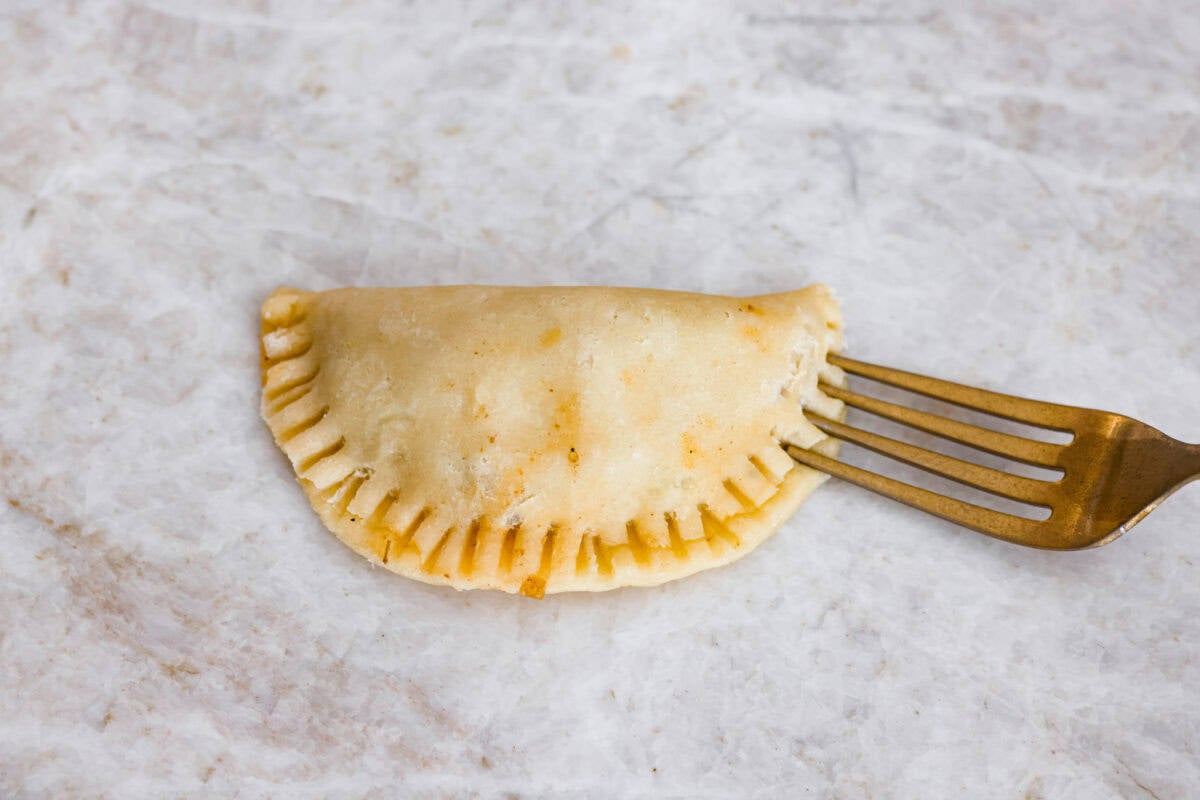Circle of dough folded over and crimped shut with a fork. 