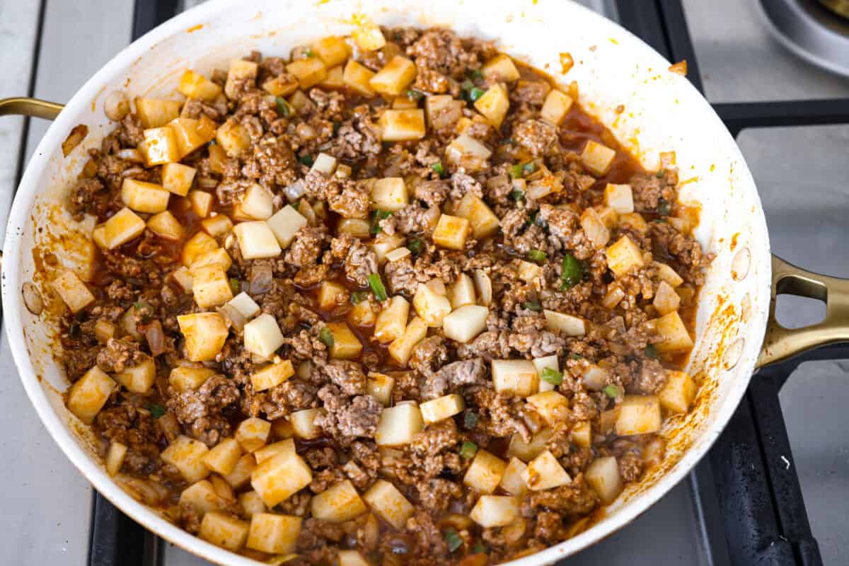 Potatoes added to the beef mixture.
