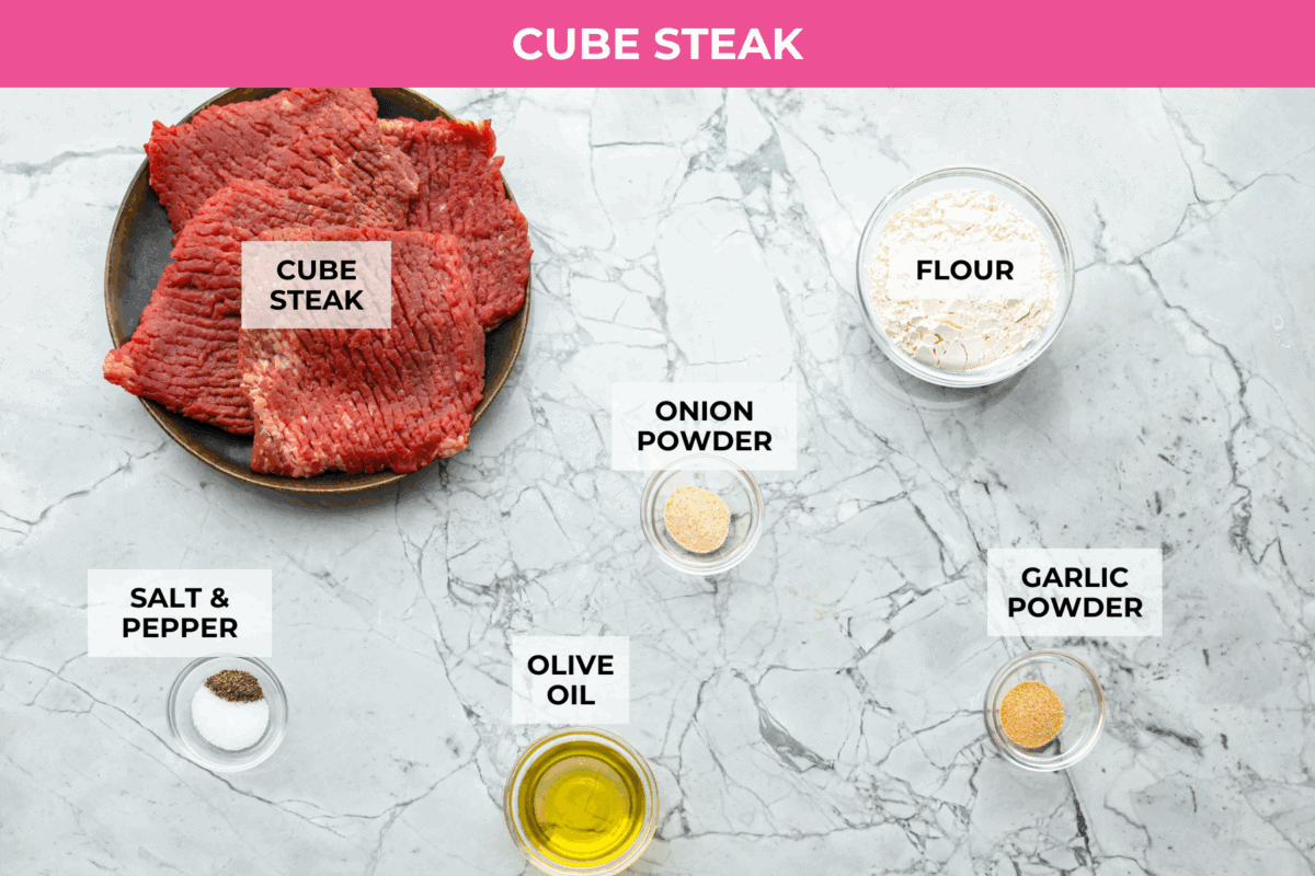 Cube steaks are my go-to budget comfort food. They're quick, cozy, and smothered in gravy. I love them with mashed potatoes or veggies, and I’ve got a simple trick to keep them melt-in-your-mouth tender every time. Overhead shot of labeled cube steak ingredients.