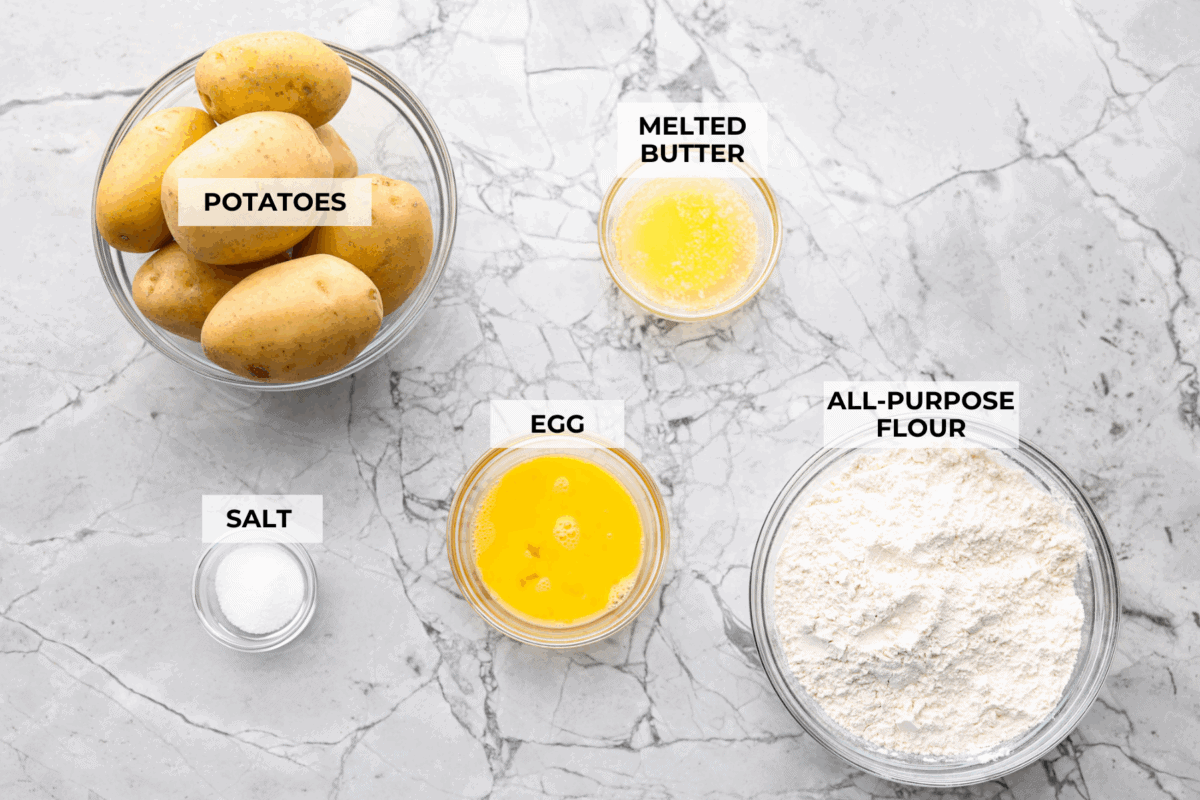 Overhead shot of labeled homemade potato gnocchi ingredients. 