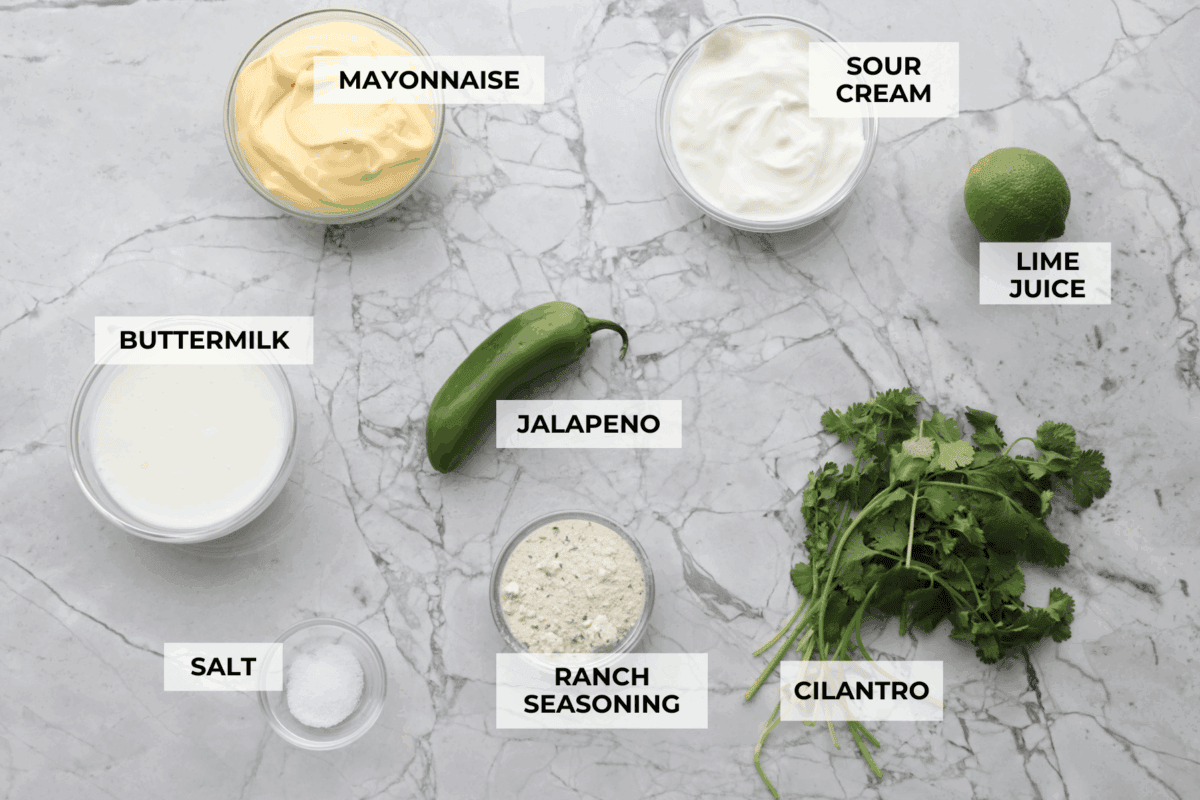 Spice meets creamy! This Jalapeño Ranch Dressing is cool, tangy, and just the right amount of zesty heat. Perfect for drizzling, dipping, or smothering on everything from salads to tacos. Overhead shot of labeled ingredients.