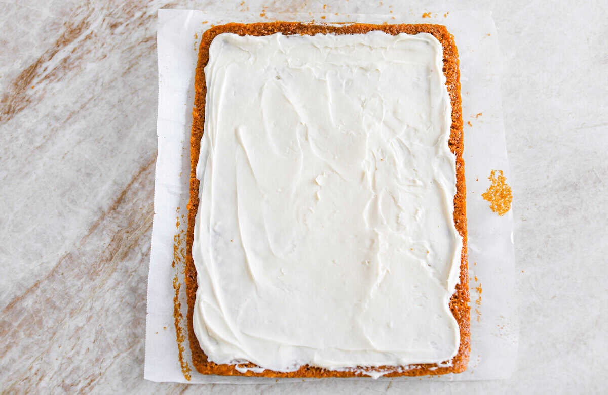 This really is the world’s best pumpkin roll! Soft, moist pumpkin cake wrapped around a sweet cream cheese filling and finished with a dusting of powdered sugar, it’s pure fall magic. The best part? It’s surprisingly easy to make. Cream cheese spread on the cooked and cooled cake.