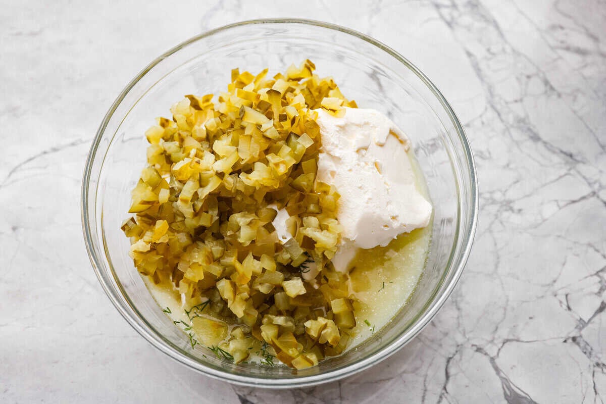 Meet my Fried Pickle Dip...a viral take on my popular pickle dip! The toasted bread crumbs elevate the flavors with the crunchy Chopped pickles and other ingredients added to a bowl.