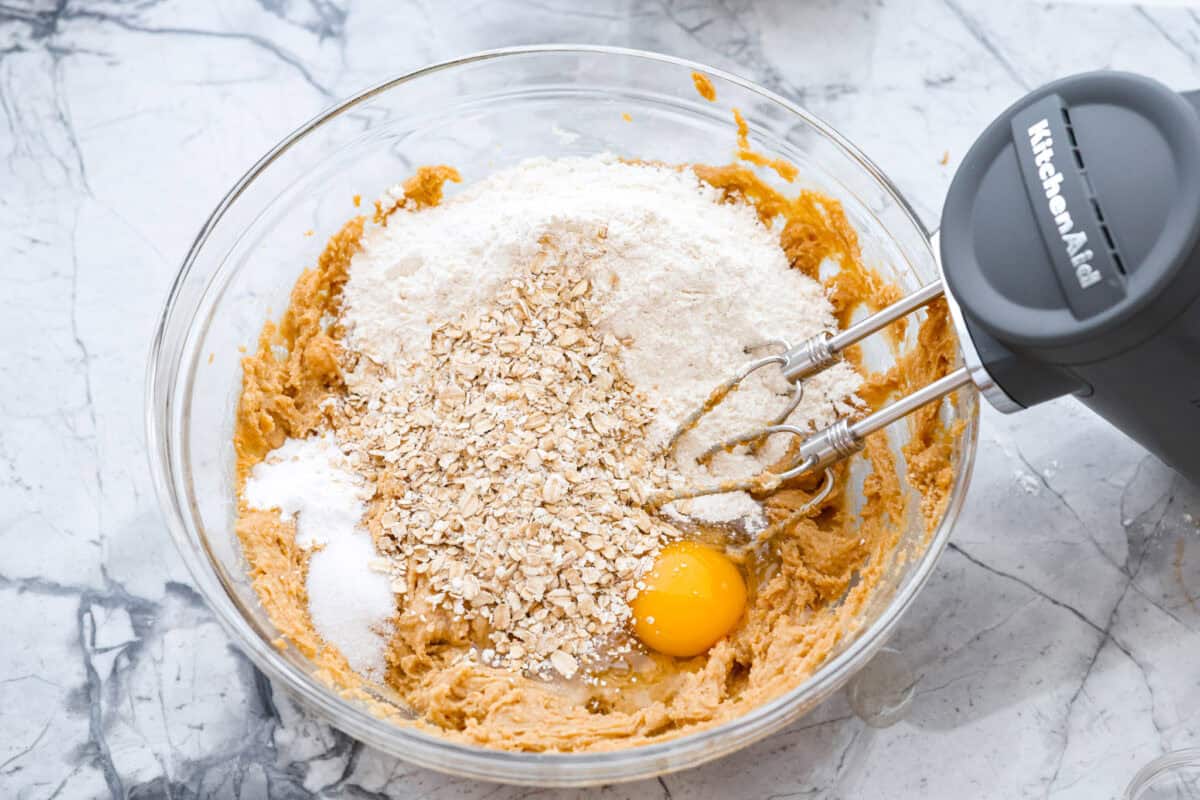Eggs, salt, baking soda, rolled oats, and flour added to the sugar and butter mixture. 