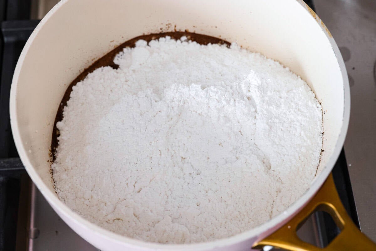 Powdered sugar added to the melted butter and cocoa powder. 