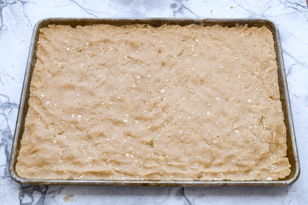 Bar batter smashed and spread out into a cookie sheet.