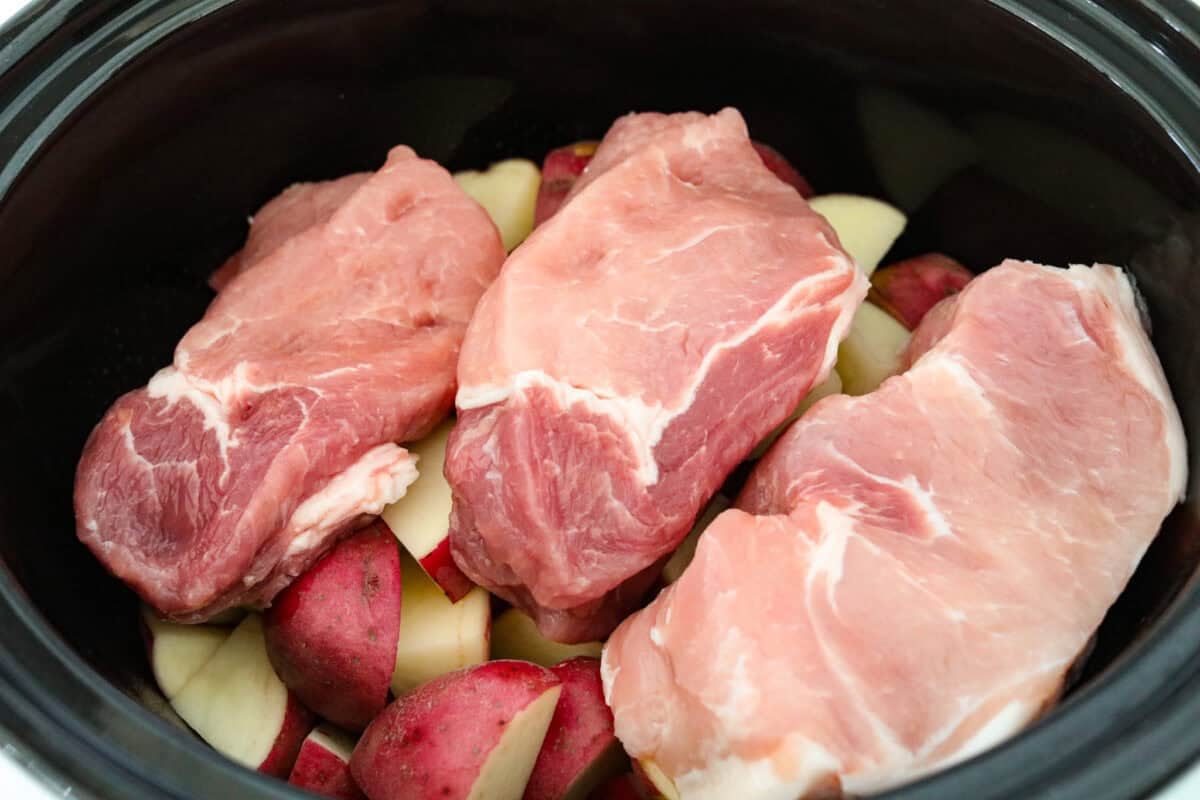 Pork chops placed on top of the potatoes.
