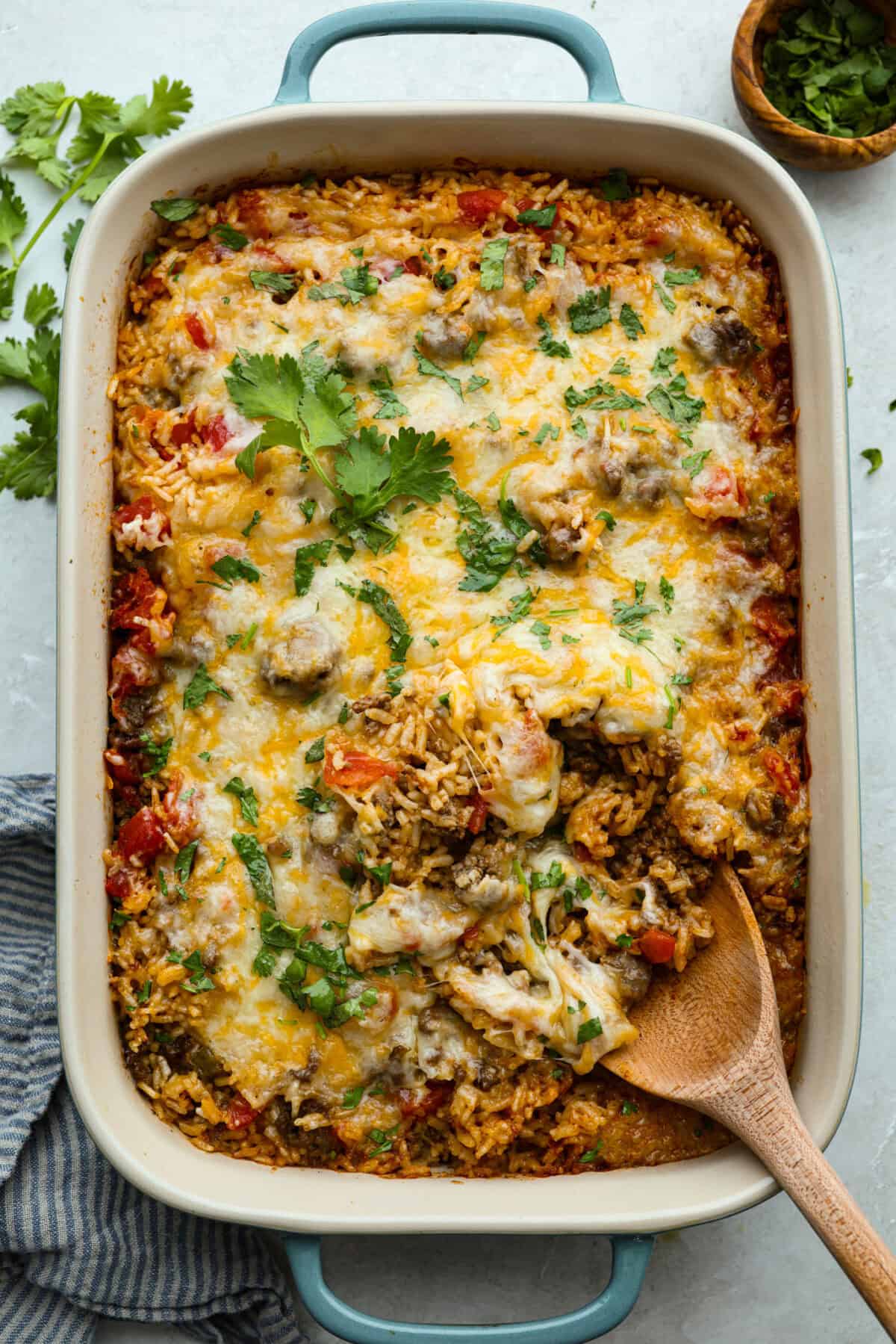 This is about to change your taco game forever! No shell needed! This dump-and-go taco rice is so easy and made with just 6 ingredients. Throw it together, top it your way, and boom, you’ve got a totally unique and delicious taco night! Casserole dish of dump and go taco rice.