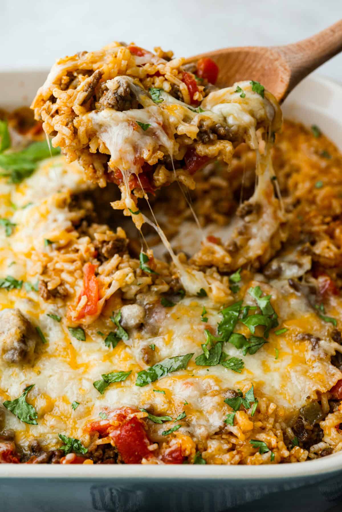This is about to change your taco game forever! No shell needed! This dump-and-go taco rice is so easy and made with just 6 ingredients. Throw it together, top it your way, and boom, you’ve got a totally unique and delicious taco night! Someone lifting a scoop of taco rice out of the main dish.