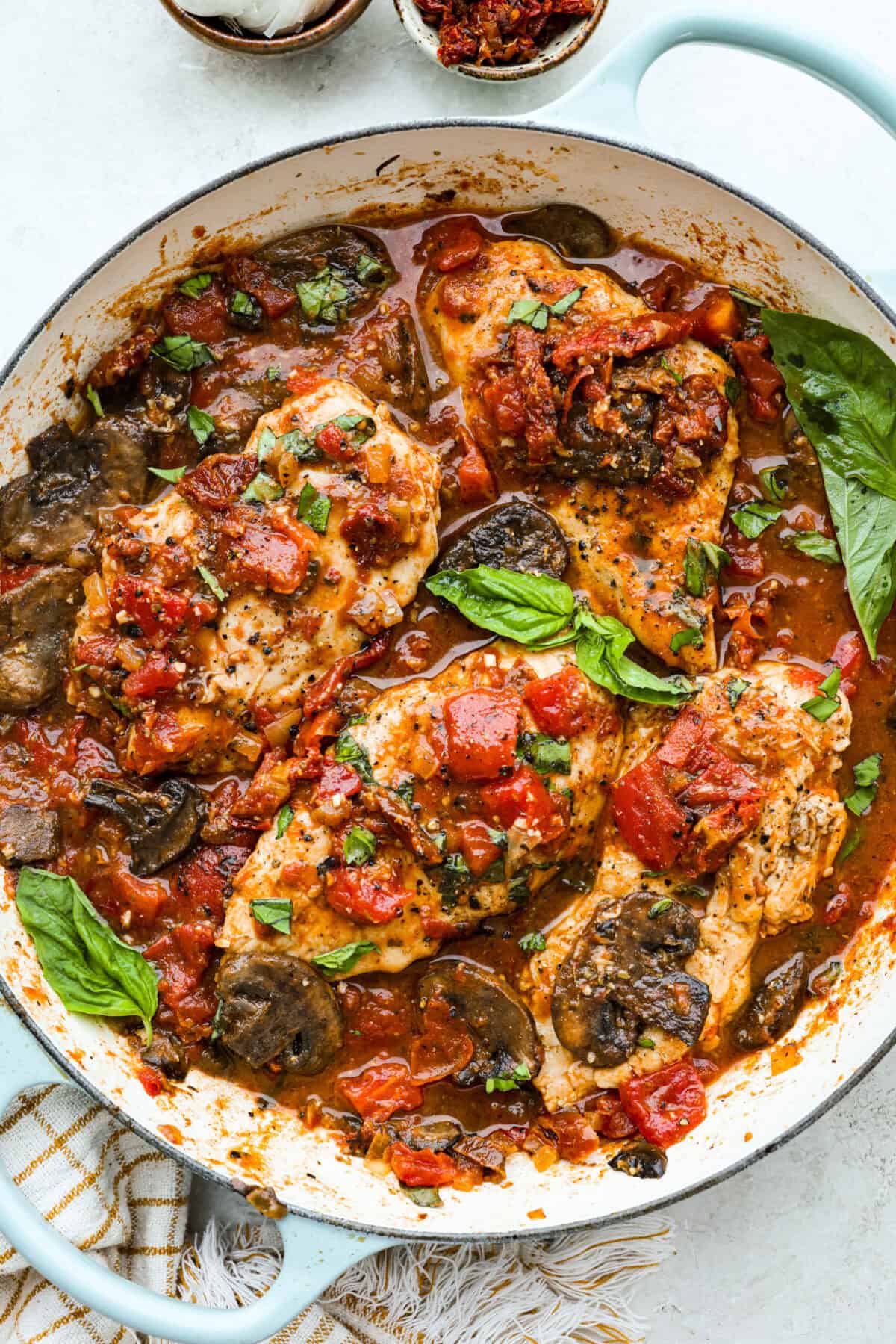 Tuscan garlic skillet chicken is one of those dinners I make and then wonder why I don’t make it more often. Juicy chicken and sun-dried tomatoes all cook together in one skillet. No heavy cream needed. Just fresh, bold flavor in 30 minutes! Tuscan garlic skillet chicken all cooked up in a skillet.