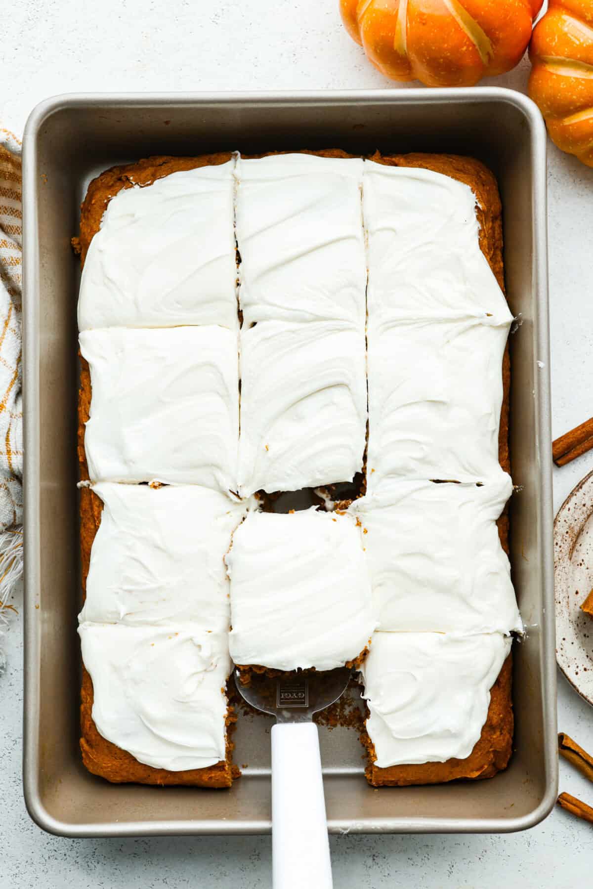 This 2 ingredient pumpkin cake comes together in minutes and bakes up perfectly spiced, tender, and fluffy every single time. It’s the ultimate dessert for any fall gathering or when the sweet tooth hits! Overhead shot of 2 ingredient pumpkin cake frosted with cream cheese frosting.