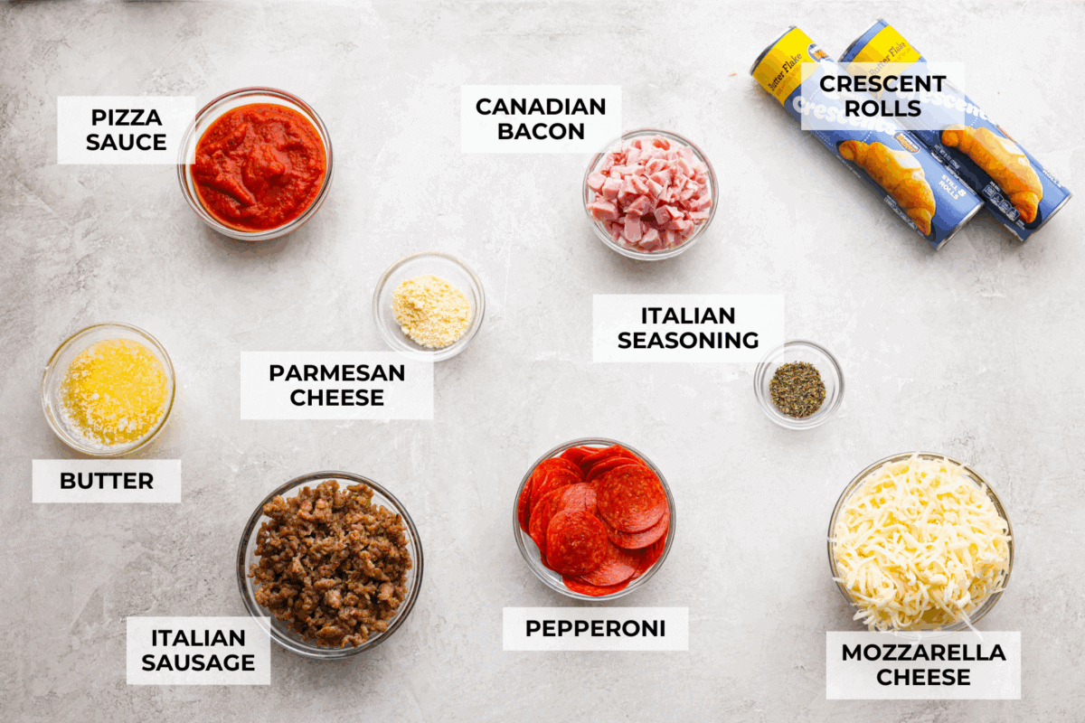 Pizza night just got a glow-up! This fun pull-apart pizza ring is perfect for family dinner, game day, or a party snack. Easy to make, endlessly customizable, and totally kid-approved, you’ll be reaching for slice after slice! Overhead shot of labeled pizza ring inrgredients.