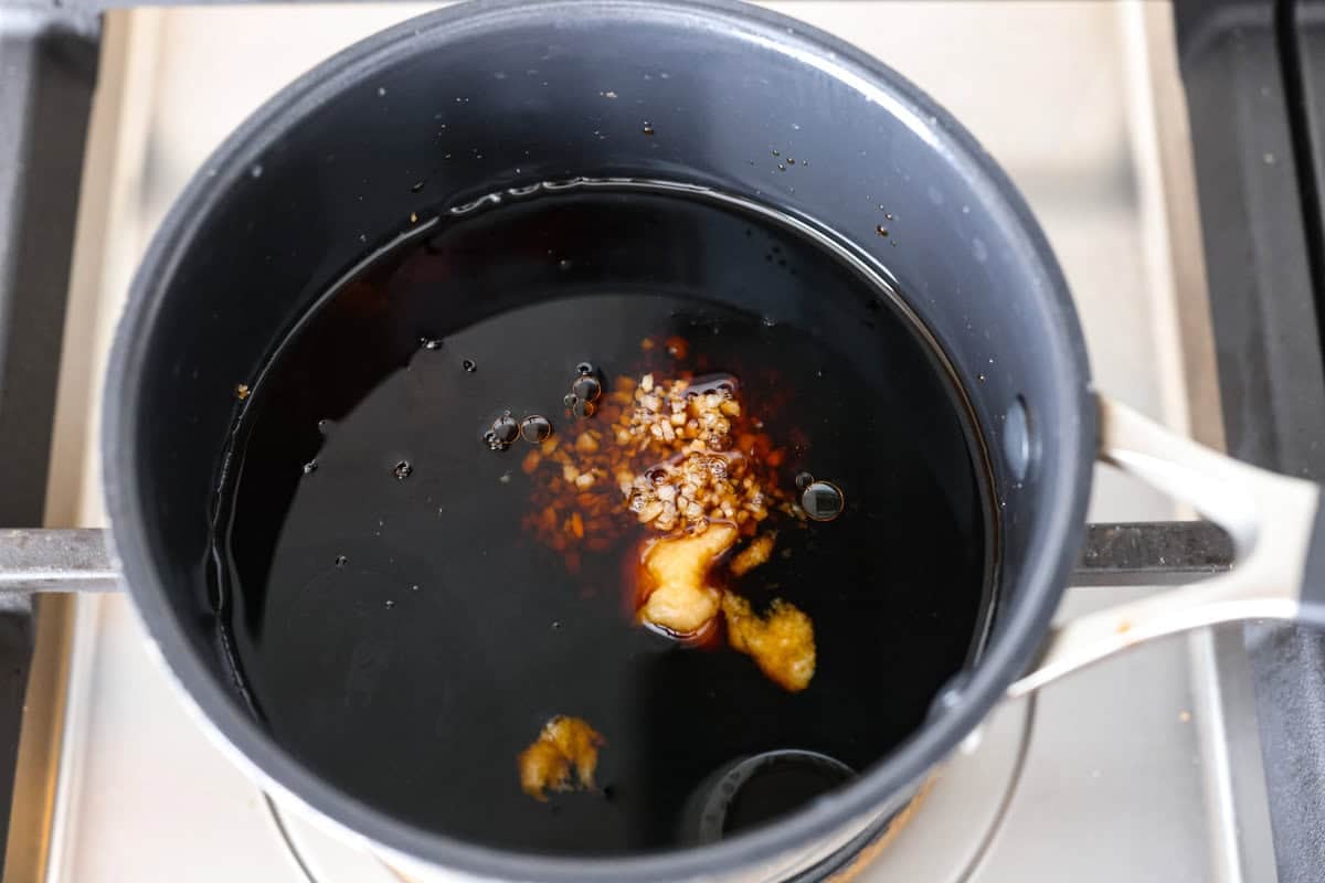 Air fryer teriyaki salmon is the best fast and tasty meal! The salmon cooks up perfectly tender with crisp edges, then gets coated in a glossy, sweet-and-savory teriyaki glaze that I know you'll love! Teriyaki sauce ingredients in a small pot on the stove.