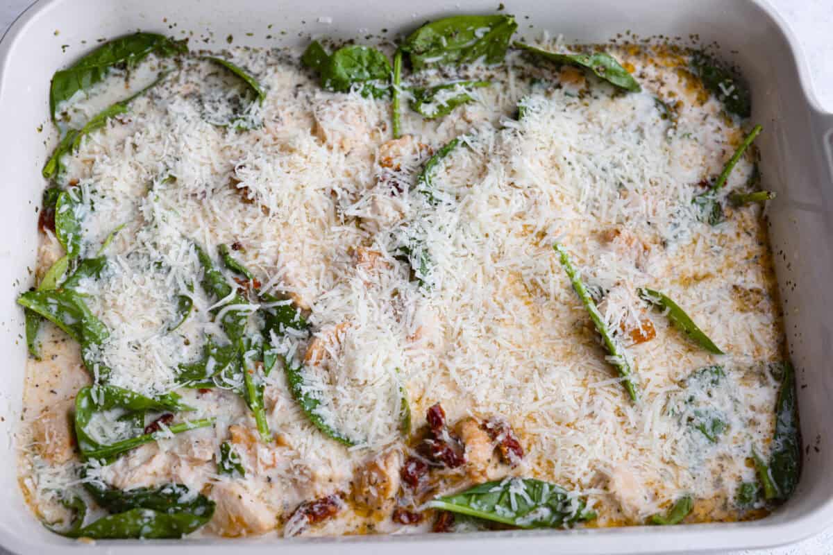 This creamy Tuscan chicken orzo bake is the kind of dinner you’ll want on repeat! Tender chicken, orzo, and sun-dried tomatoes bake together in one pan for an easy, comforting weeknight meal. All of the ingredients stirred together and covered with parmesan cheese.